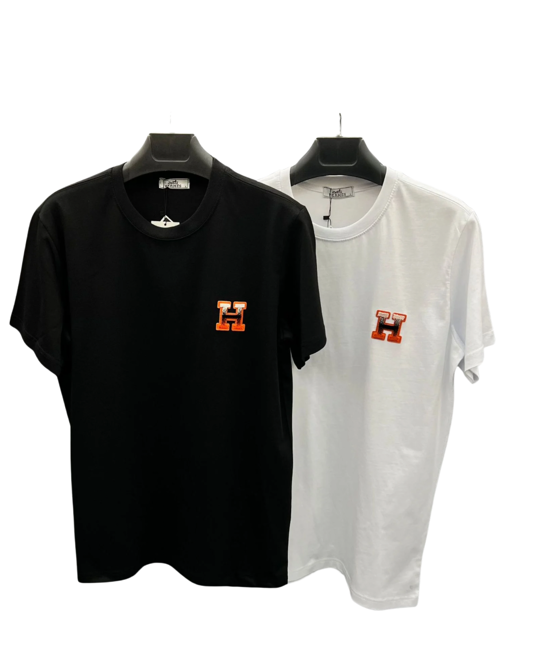 Black and white H logo T-shirts on hangers