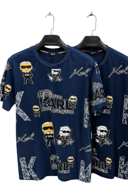 Two navy blue Karl Lagerfeld graphic t-shirts hanging on black hangers against a white background. The shirts feature an all-over print of the brand's signature cartoon character, Karl the Dog, and 'Karl Lagerfeld' text.